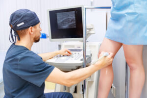 Doctor performing venous ultrasound before endovenous laser therapy